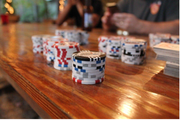 close up of poker chips on a wooden table