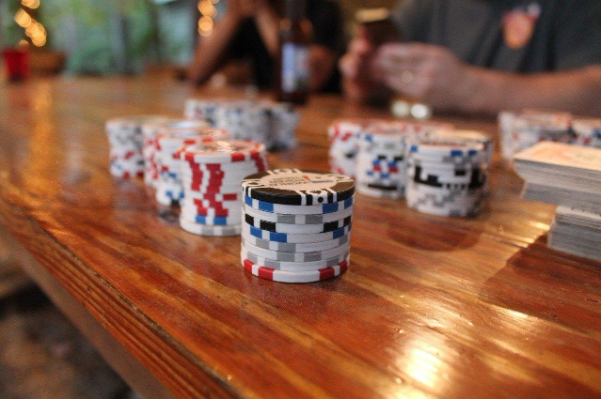 close up of poker chips on a wooden table 